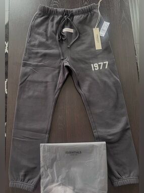 Fear of God Essentials Sweatpants in Charcoal with 1977 Print